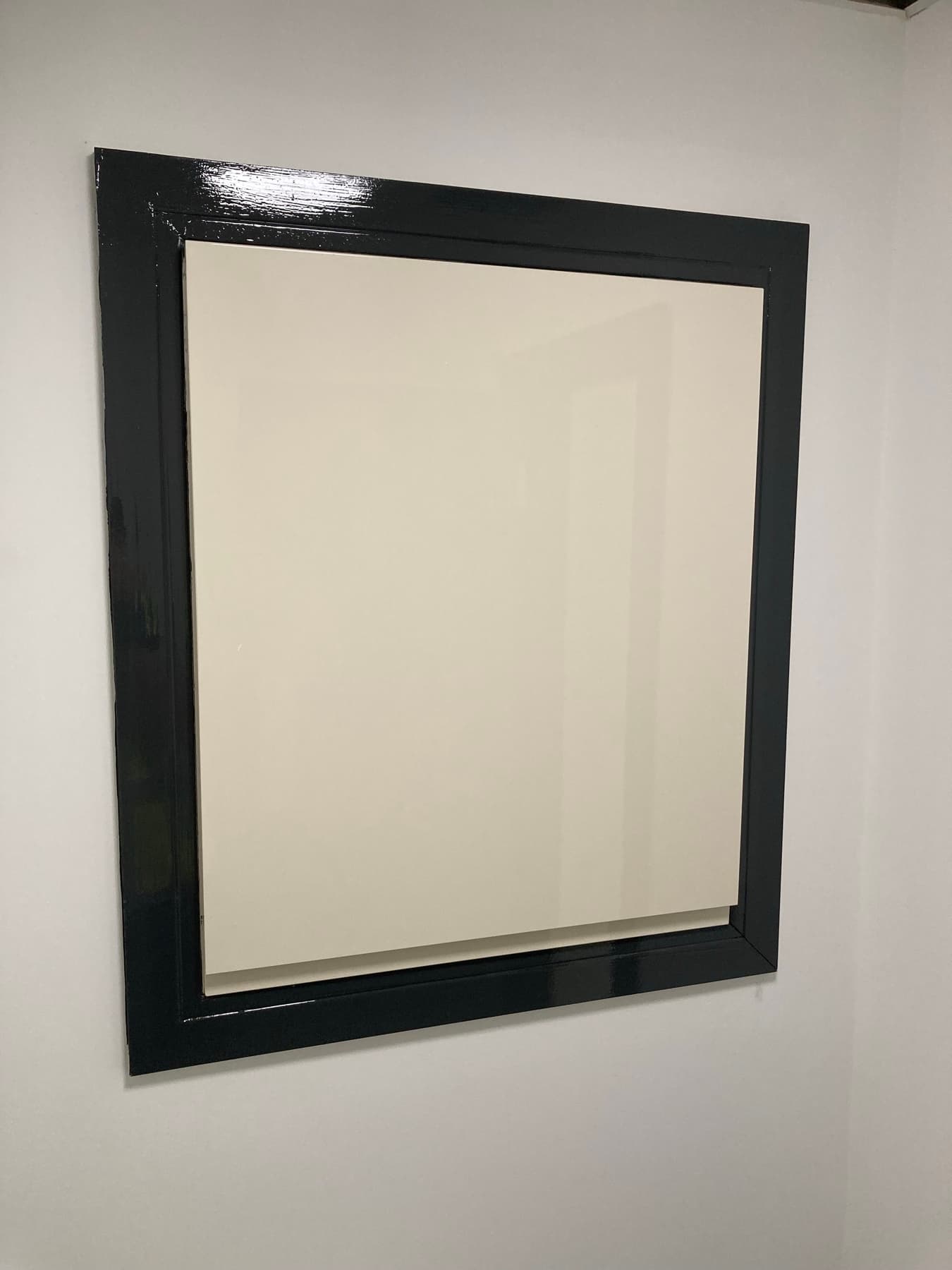 Fire door with crisp charcoal frame and precise white wall cutting-in