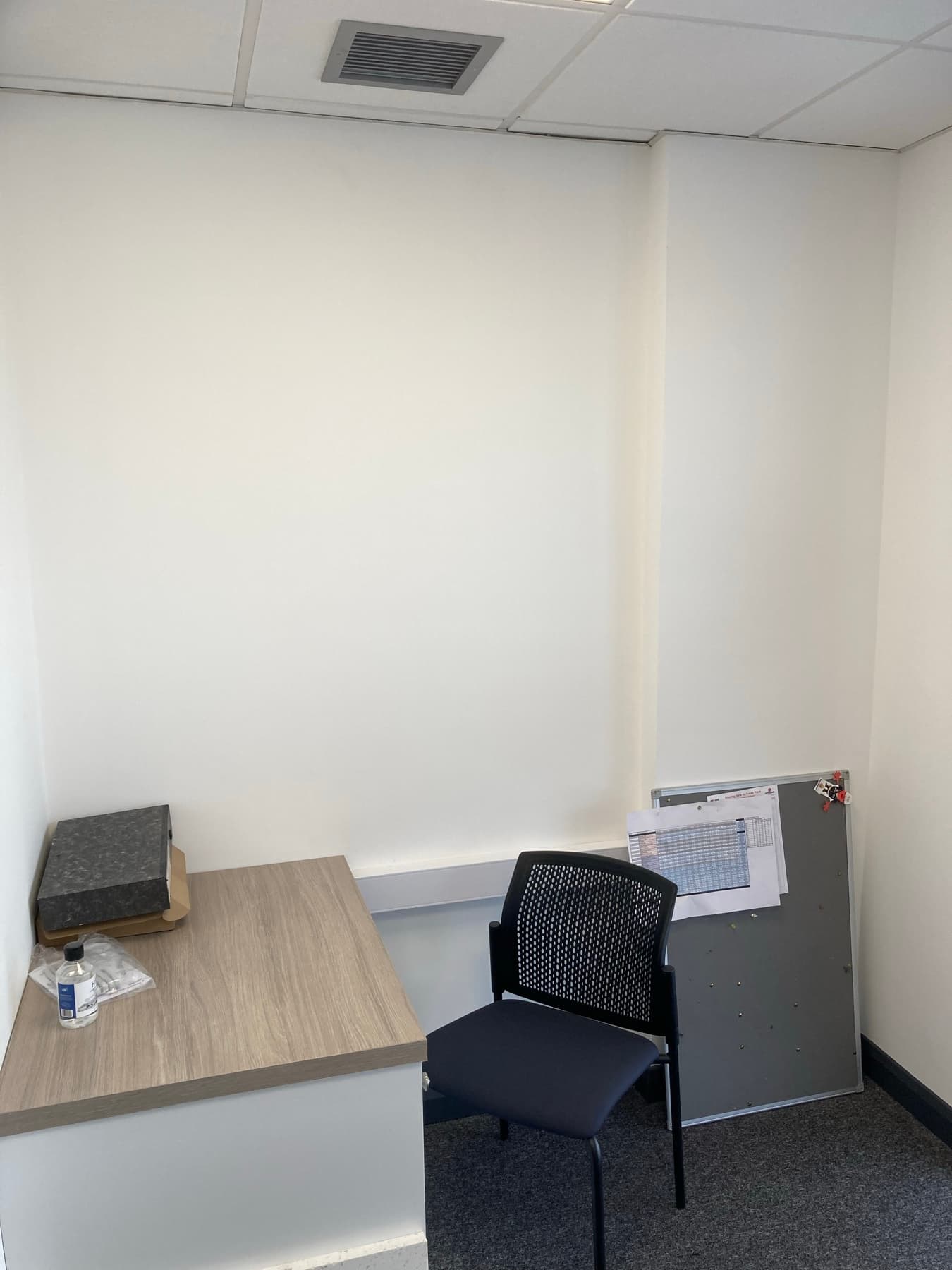 Office wall finished in durable emulsion beside built-in cabinetry