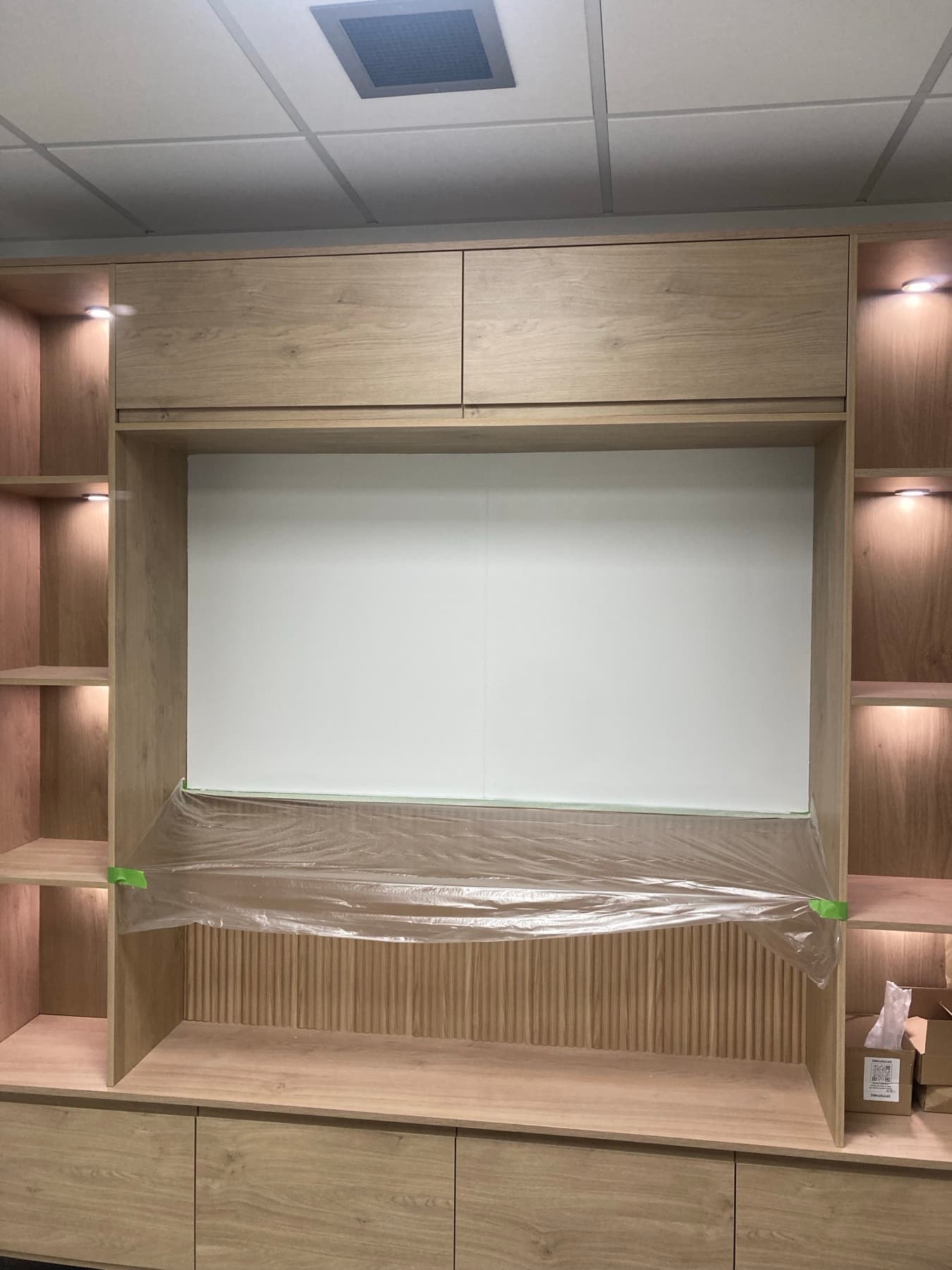 Office interior with built-in shelving and clean wall finish